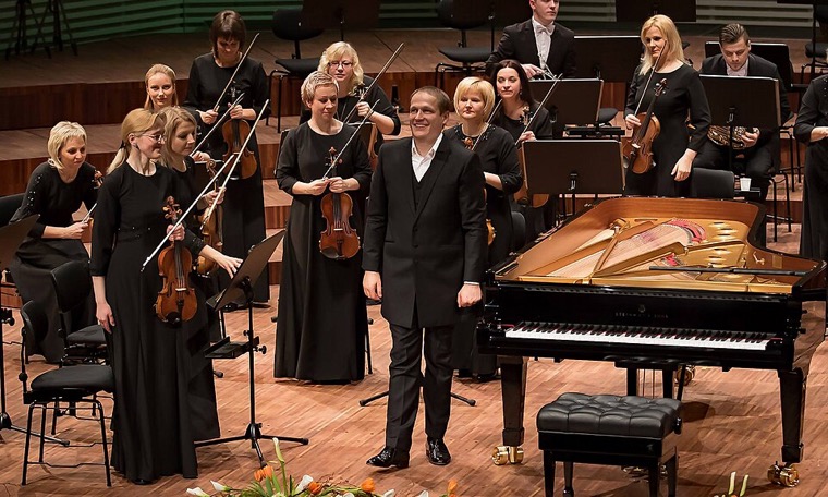 A conductor leading a symphony orchestra